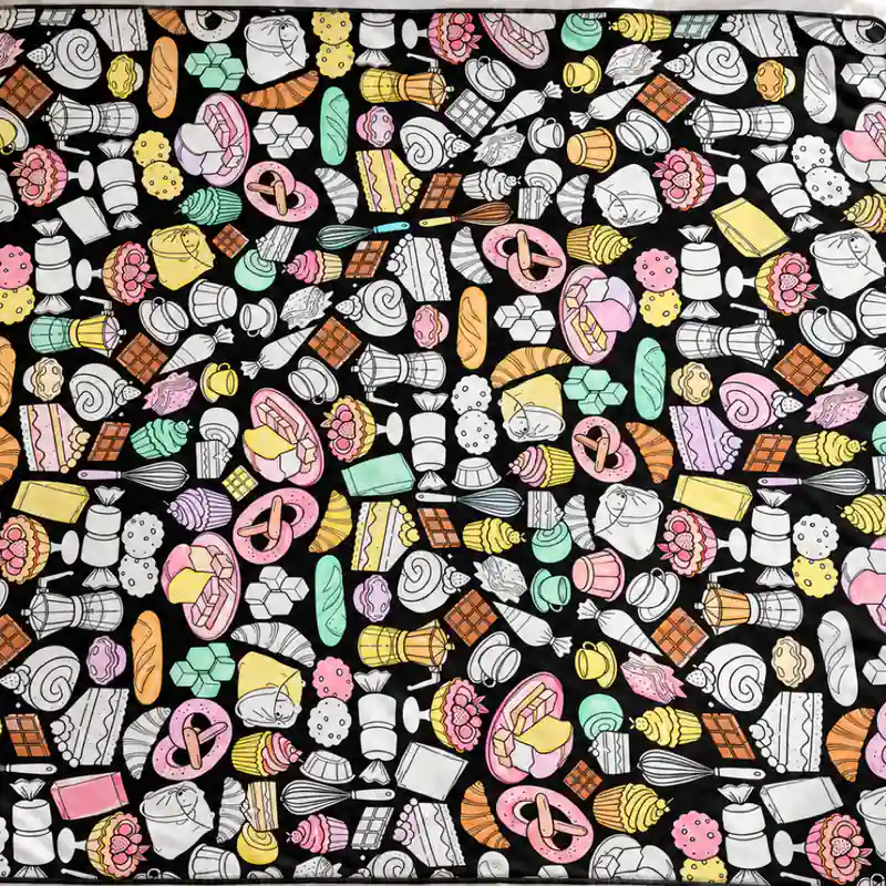A coloring blanket design laid flat with fabric markers beside it